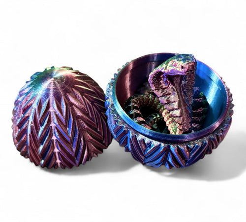 3D printed snake scale egg fidget toy in green blue and purple with jointed snake figurine inside