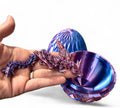 3D printed winged dragon with scale egg fidget toy in blue and purple with articulated wings and body