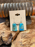 Turquoise slab fishhook earrings with silver-tone hooks and speckled blue stone faces