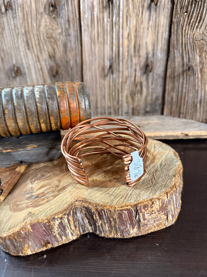 Copper wire cuff bracelet with open round twisted weave and small size tag