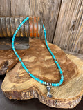 Kingman turquoise beaded necklace with silver blossom pendant and bell charm