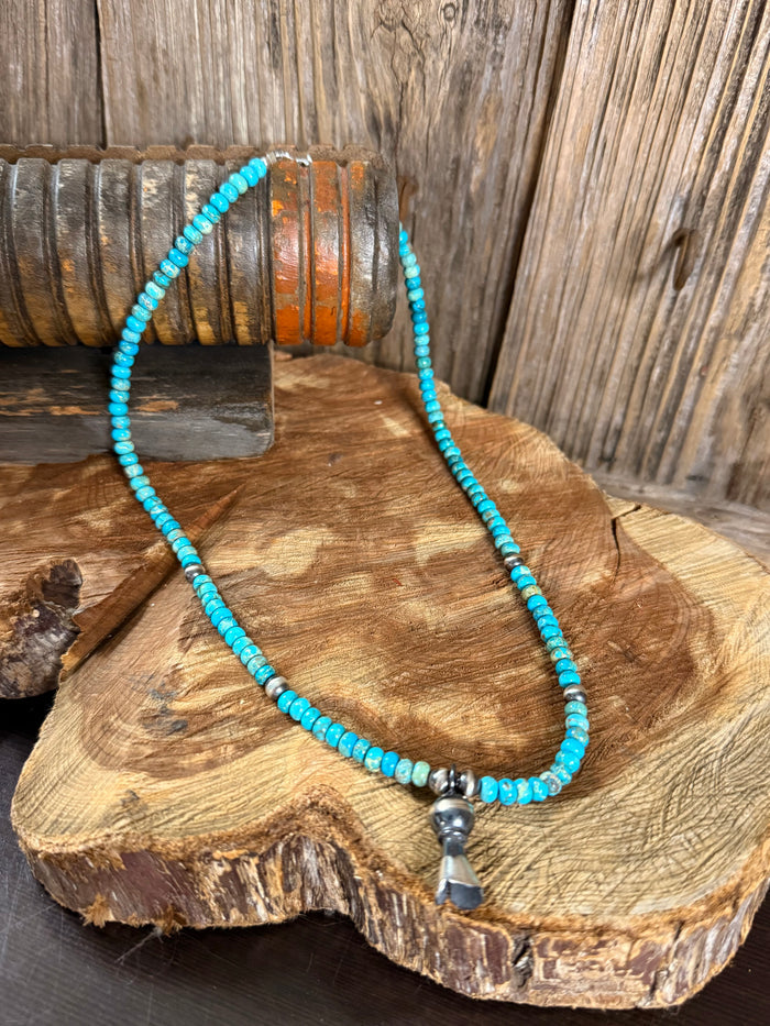 Kingman turquoise beaded necklace with silver blossom pendant and bell charm