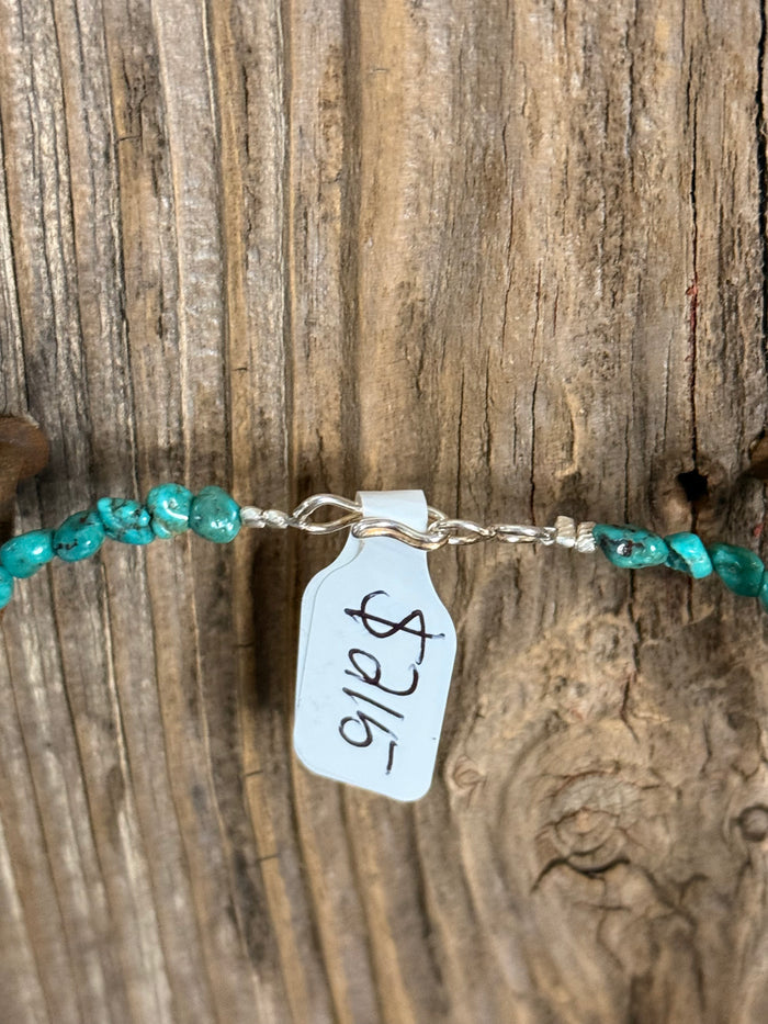Turquoise bead necklace clasp with dangling 'Adios' tag and silver connector.