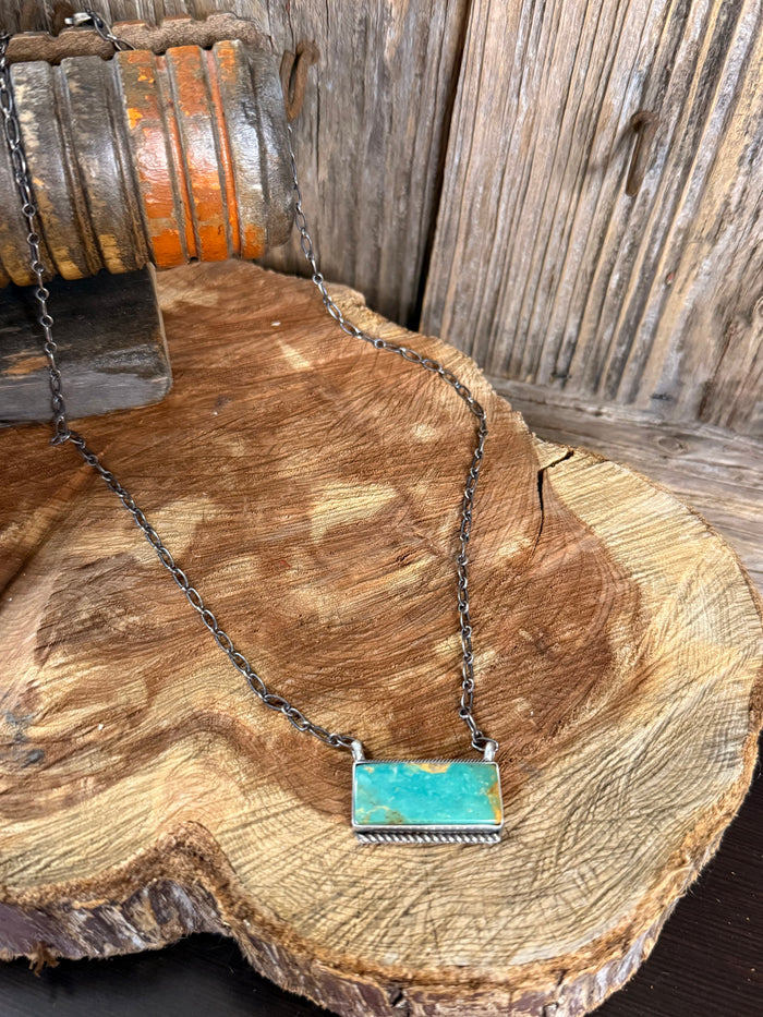 Turquoise bar necklace with silver-toned chain and rectangular turquoise pendant
