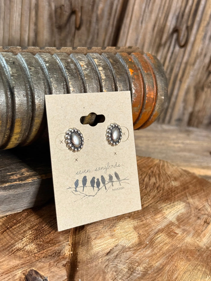 Sterling silver oval concho stud earrings, beaded rim around central dark dot