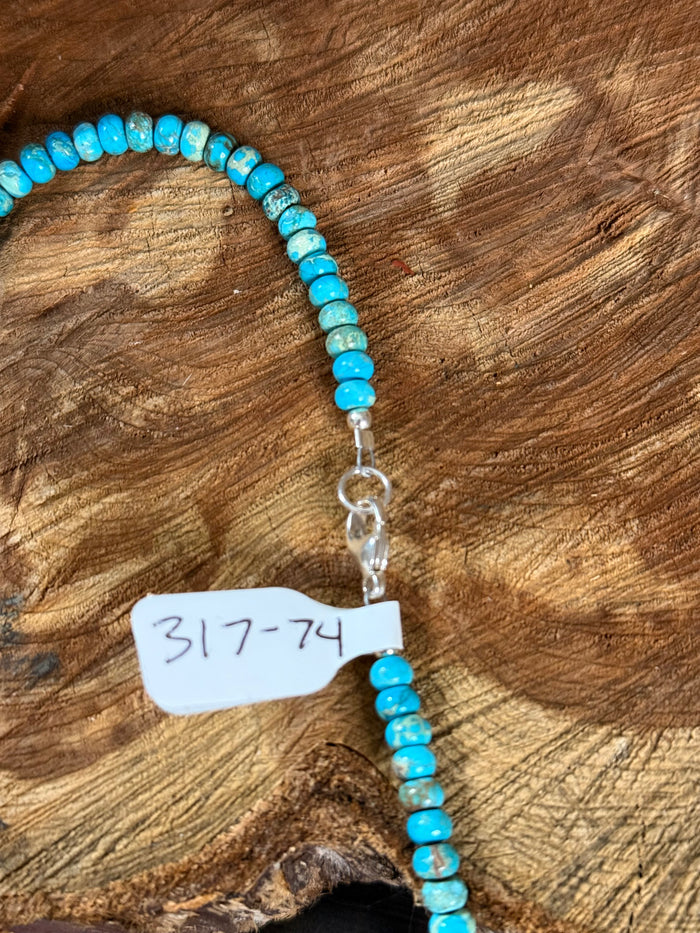 Kingman turquoise beaded necklace with small silver clasp and dangling charm