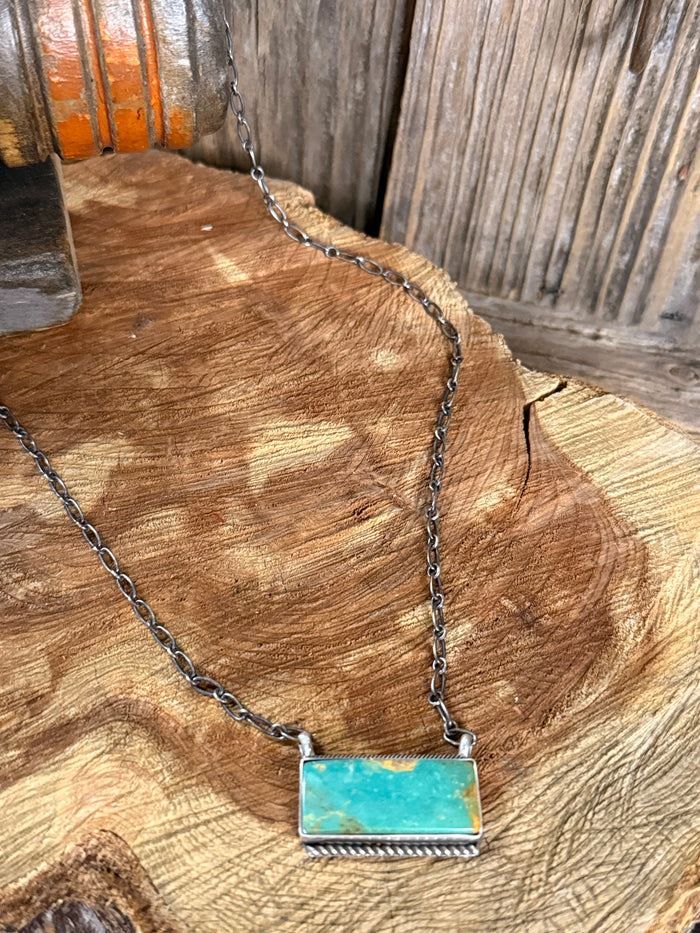 Turquoise bar necklace with rectangular turquoise pendant on silver-toned chain