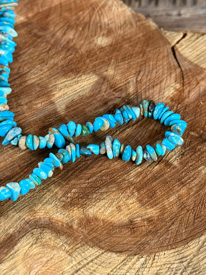 Close-up of turquoise chip bead necklace, stacked stone chips