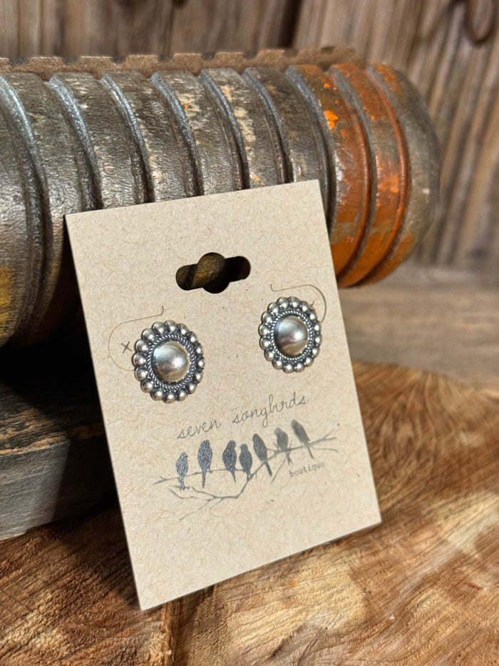 Round concho-style silver stud earrings with pearl-like center and bead halo