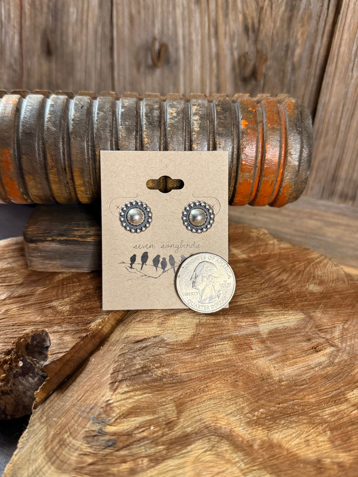 Round silver stud earrings featuring pearl-like center with decorative beaded edge