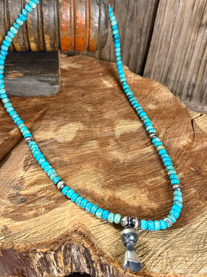 Kingman turquoise beaded necklace with silver flower pendant, close-up view