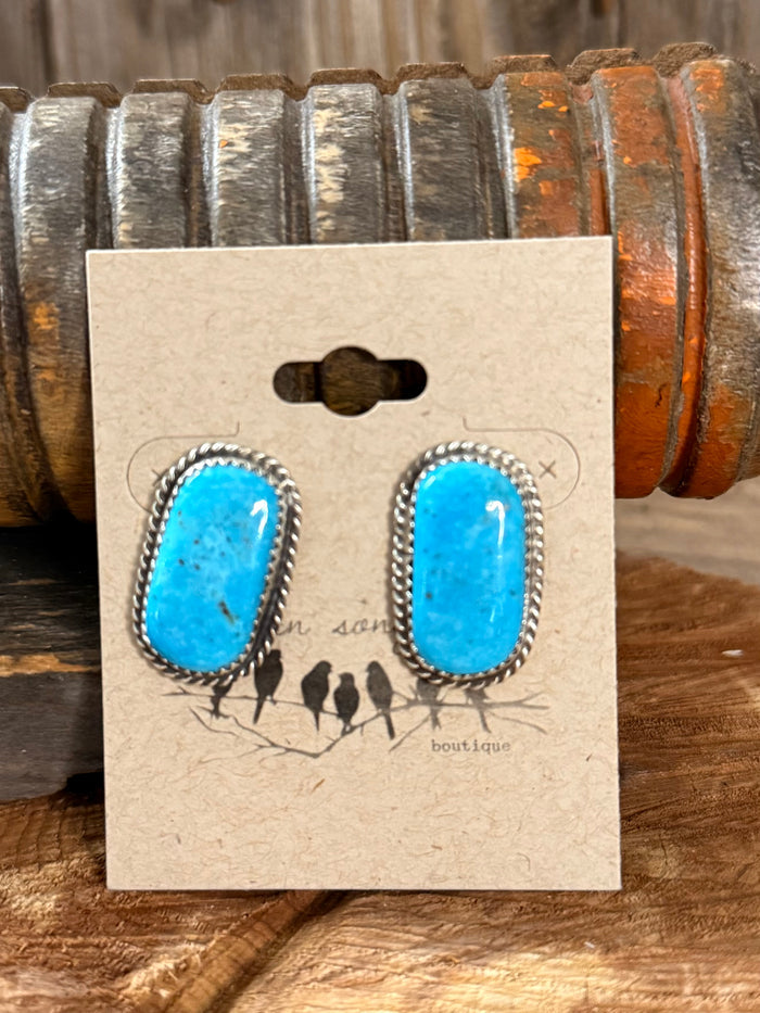 Turquoise oval stud earrings with silver border, pair on presentation card