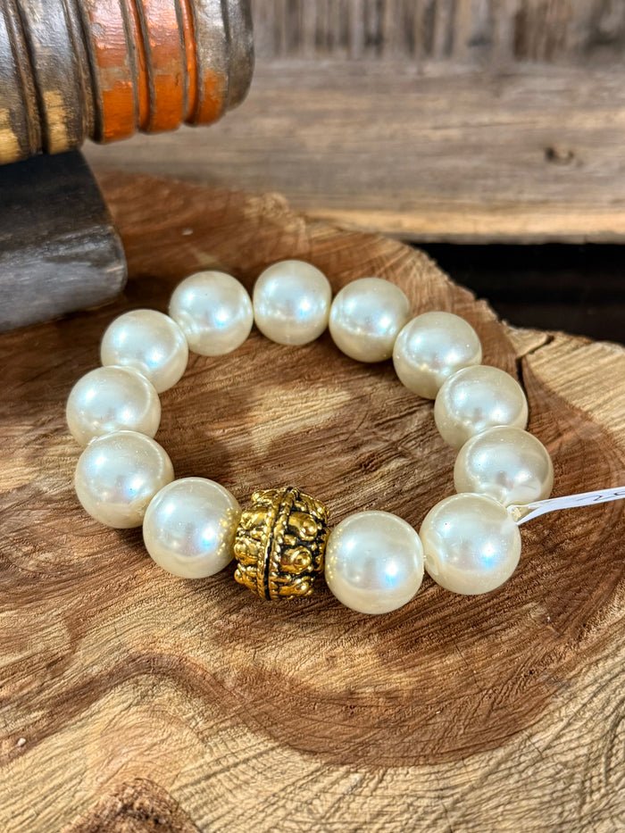 Iridescent pearl stretch bracelet with round pearls and gold filigree center bead