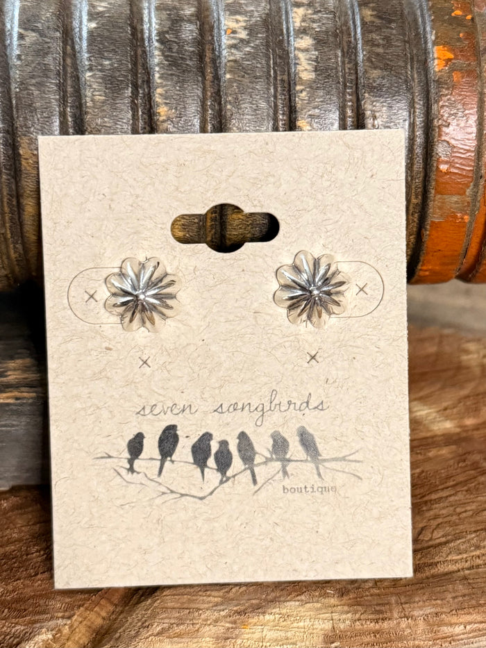 Sterling silver stud earrings with starburst flower design shown on display card