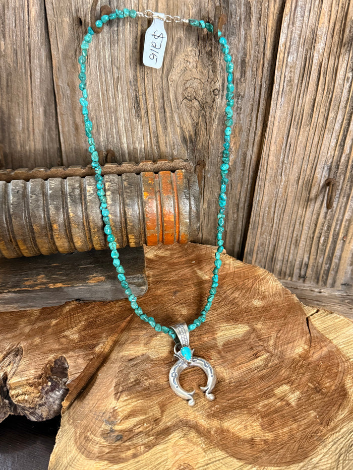 Turquoise bead necklace with silver Naja pendant, 16 in length.
