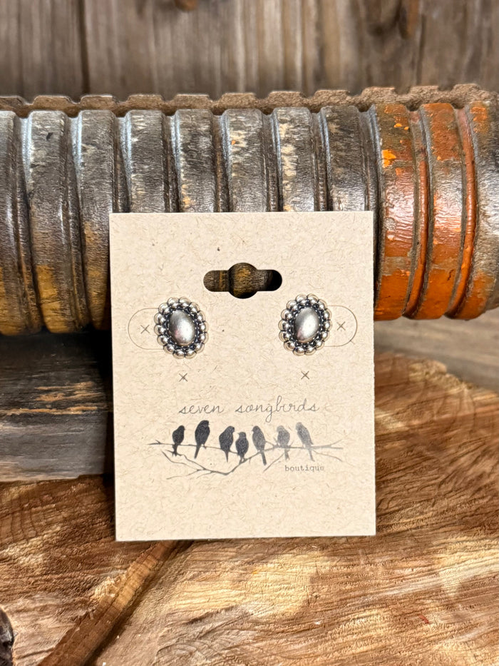 Sterling silver oval stud earrings with textured beaded halo and dark center