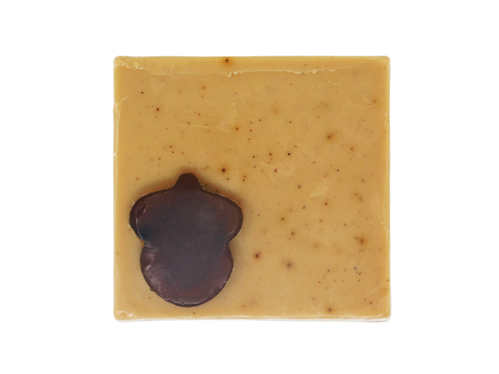 light brown coffee speckled square soap  with dark brown acorn shaped soap on top