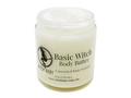 4 oz glass jar containing white body butter topped with milk quartz. Label says unscented basic formula.