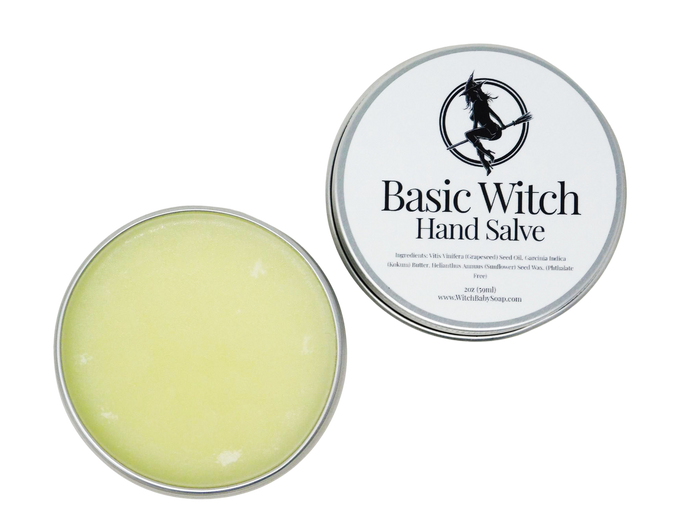 Circular tin containing hand salve. Label says Basic Witch Hand Salve.