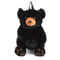Black bear plush backpack facing forward with amber muzzle and embroidered paw pads, white background