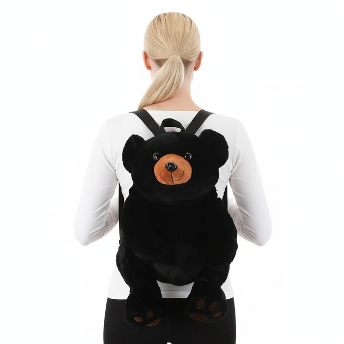 Back view of woman wearing black bear plush backpack with adjustable straps, white background