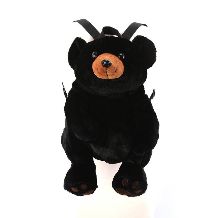 Front view of black bear plush backpack standing upright showing full bear face, amber muzzle, and paw pad details, white background