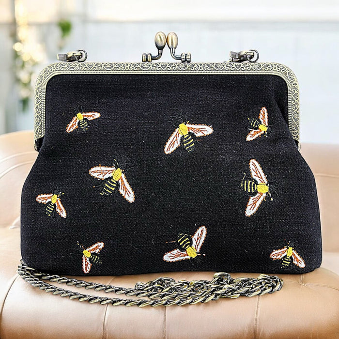 Black bees kisslock bag front view showing intricate bee motifs on natural cotton and linen blend fabric with vintage metal kisslock closure by GoodStuff Co