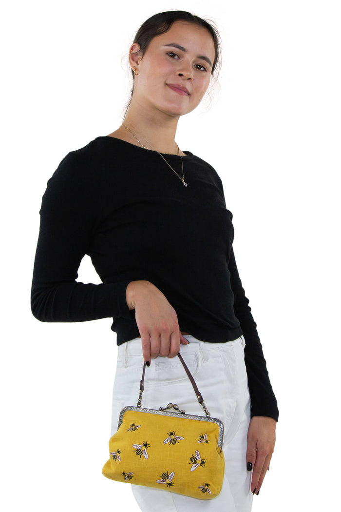 Bees kisslock bag open showing polka dot fabric-lined interior and interior zippered pocket for organization by GoodStuff Co