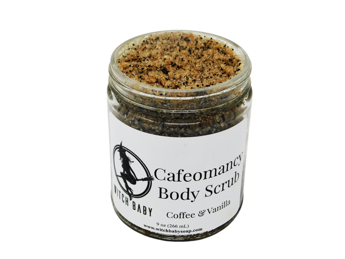 9 oz glass jar containing coffee scrub. Dark brown in color. label says cafeomancy body scrub coffee and vanilla.