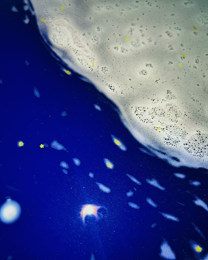close up of gold stars in blue water