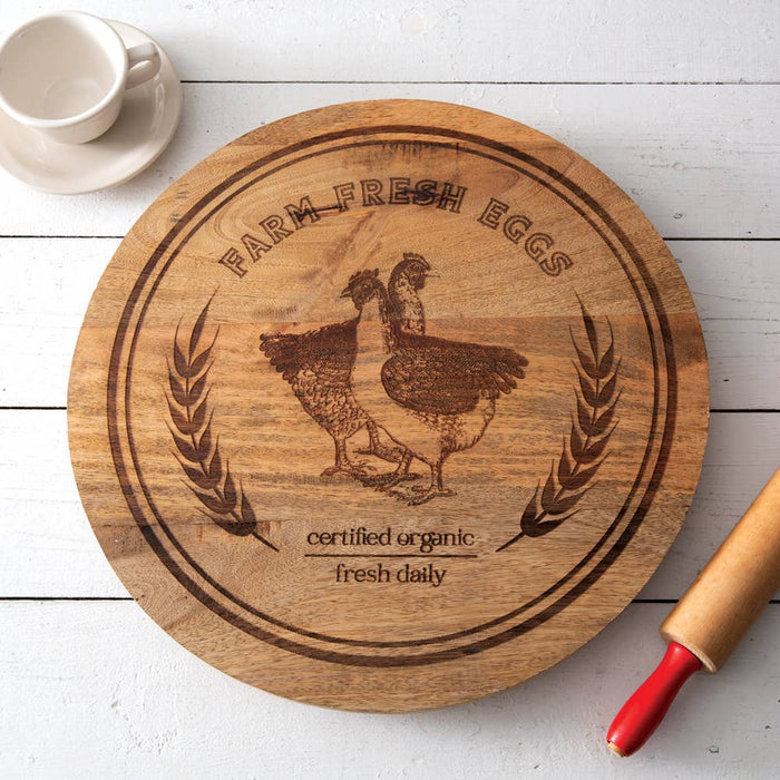 Top-down view of 18-inch Farm Fresh Eggs wooden lazy susan showing full chicken motif artwork, natural wood grain, and rotating turntable base — farmhouse kitchen and dining room decor