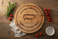 Farmer's Market lazy susan rustic wood spinning turntable with hand-painted pig motif and farmhouse lettering, 18-inch diameter, natural wood grain finish — farmhouse kitchen and dining table centerpiece by CTW Home Collection - farmhouse setting
