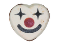 A heart-shaped white bath bomb decorated with a black glittery star-eyed smiley clown face and a glittery red nose, isolated on a white background.