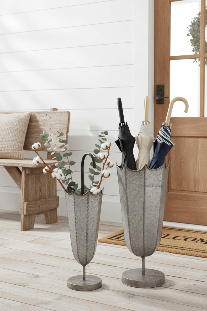 Galvanized umbrella stands in farmhouse entryway with umbrellas and dried florals