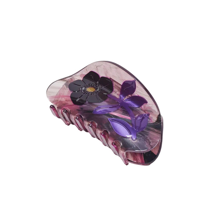 Purple floral hair clip on a white background