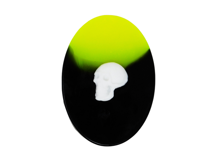 neon yellow and black oval soap with white skull on top