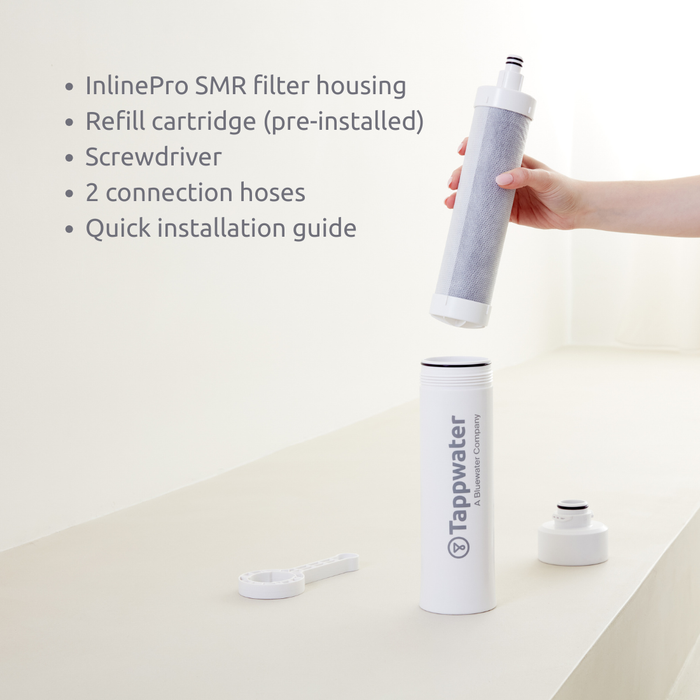 Tappwater filter housing with refill cartridge, screwdriver, and connection hoses on a white background.