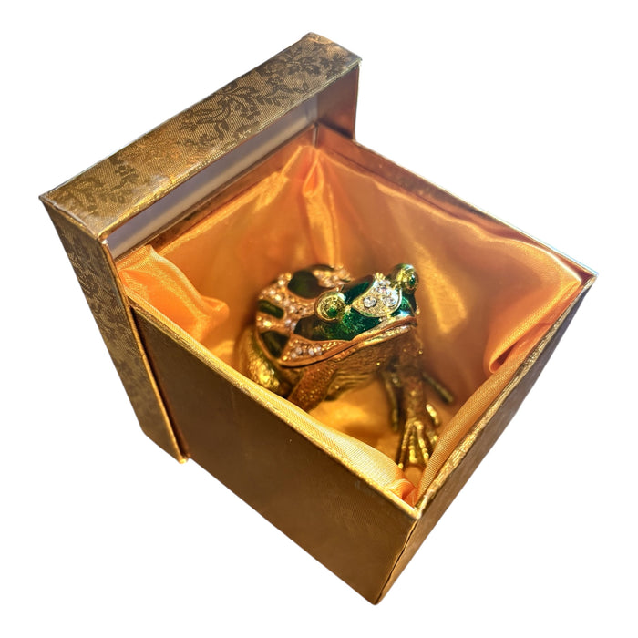 eweled green enamel frog trinket box nestled inside open gold brocade gift box showing terracotta satin interior lining