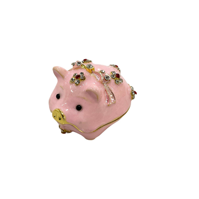Pink enamel jeweled pig trinket box on white background, three-quarter front view showing rhinestone flowers and gold snout detail