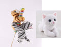 Orange tabby and grey tabby Lollyplush cat plush toys each hugging a colorful rainbow lollipop on a wooden stick, white background, with white kitty plush inset