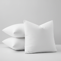 Luxury 22x22 white goose feather down pillow inserts stacked on a soft grey-white background – clean product shot