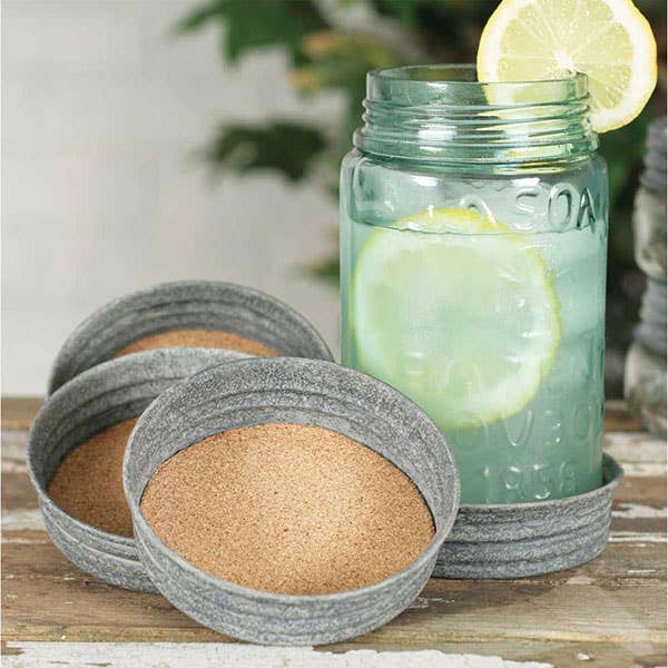 Happy Camper mason jar lid coasters stacked and displayed together – set of 4 cork-lined coasters with cheerful camping print, fits wide-mouth Mason jars