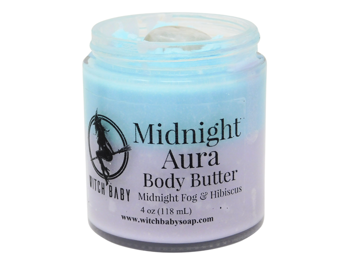 half blue half purple body butter in a glass jar with a moonstone on top and a clear label that reads: Midnight Aura Body Butter. Midnight Fog & Hibiscus.