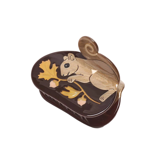 Decorative claw clip with a gold squirrel design on a white background