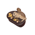 Decorative claw clip with a gold squirrel design on a white background
