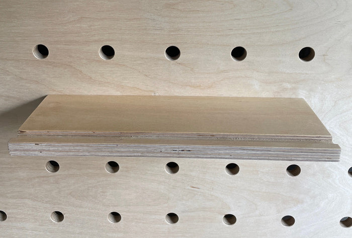 plywood shelf with groove -  groove prevents picture frame to slid off