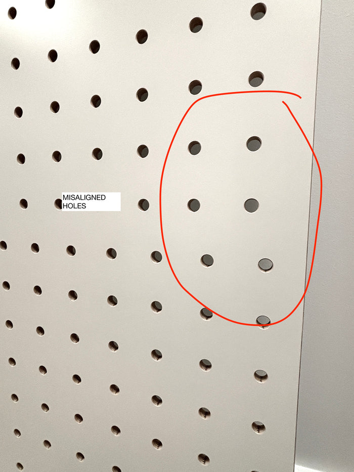Pegboard with misaligned holes highlighted by a red circle and text label.