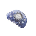 Blue hair clip with sun and star design on a white background