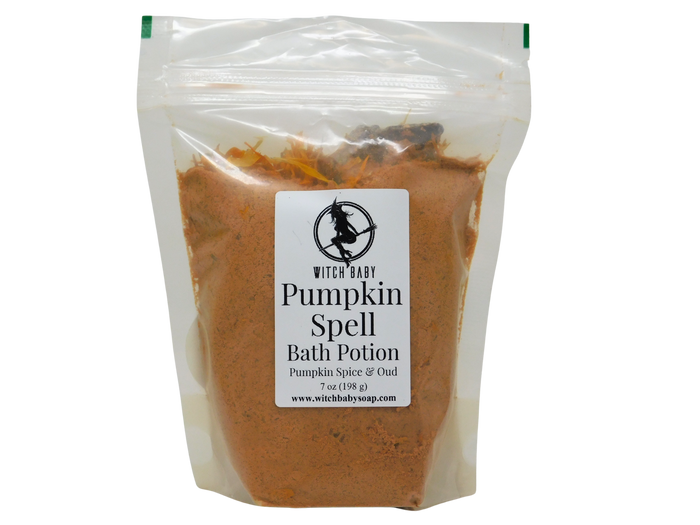A clear plastic stand-up pouch containing an orange-brown bath potion powder, with a white label reading 'Witch Baby Pumpkin Spell Bath Potion' on a white background.