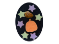 An oval black soap featuring a Halloween design with a carved orange pumpkin, a tumbled fire agate crystal, and six pastel star cutouts in purple and light green.